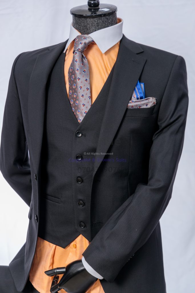 kampala-four-dress-codes-wool-suits — Part 3 ## Quick Checklist: Choosing the Right Wool Suit for the Dress Code
Use this fast checklist before you dress:
- **Read the invitation:** Does it say casual, smart casual, business/business formal, or black tie?
- **Pick the right base color:**
- Smart casual/business: navy, charcoal, grey
- Black tie: traditional dark formal tones
- **Check fit first:** shoulders aligned, jacket closes cleanly, trousers sit well at the waist
- **Match formality with details:** tie or no tie, shoe choice, and accessories should fit the level
- **Avoid extremes:** too tight, too loose, too shiny, or too loud for the setting
If you attend a black-tie wedding or evening function, use a guide that focuses on the correct formal details so you do not guess.
Link to this article to help readers choose the correct wool suit details for black-tie events, especially weddings and evening functions. https://suitsavenue.blog/black-tie-wedding-suit-men-kampala-style-guide/
Click the WhatsApp button to speak with Suits Avenue and get help choosing the right piece. — Part 3