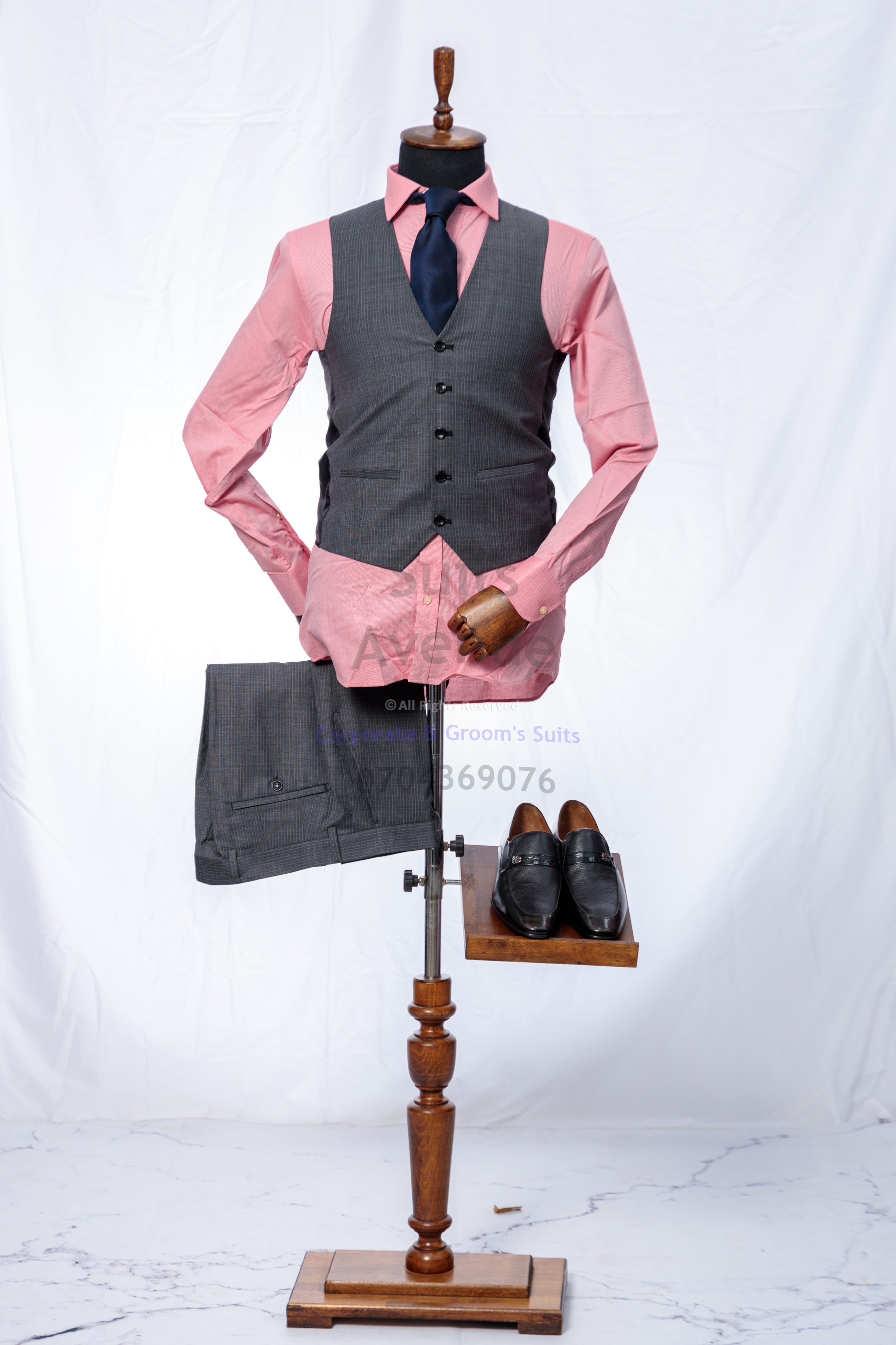## Quick Checklist Before You Buy (Plus Simple Styling Advice)
Use this final checklist to make a confident choice:

- **Fabric:** Feels breathable, smooth, and resilient; not overly thin or stiff.
- **Jacket shoulders:** Seam sits cleanly at your shoulder edge.
- **Jacket buttoning:** Buttons close without pulling; lapels lie flat.
- **Sleeves:** Comfortable movement; balanced length.
- **Trouser fit:** Comfortable waist, smooth seat, clean leg line.
- **Finish:** Even stitching, neat buttonholes, tidy inside seams.

Simple styling tips for a professional Kampala wardrobe:
- Choose a shirt that sits clean at the collar and cuffs (no gaping).
- Keep your belt and shoes in the same color family for a coordinated look.
- Rotate your suits and hang them properly to help the wool recover its shape.

Click the WhatsApp button to speak with Suits Avenue and get help choosing the right piece. — Part 3